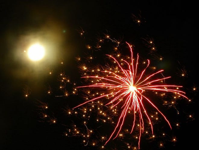 Fireworks are seen with the bright Moon in the background (New Year’s Eve, 2009). [Dnalor 01/Wikimedia Commons]