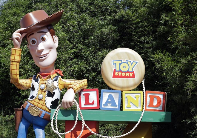 A statue of the character Sheriff Woody greets visitors at the entrance Toy Story Land in Disney's Hollywood Studios at Walt Disney World in Lake Buena Vista. [AP Photo/John Raoux]