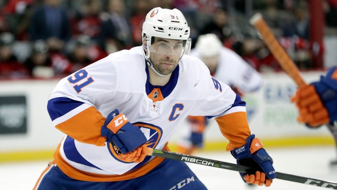 FILE - In this Saturday, March 31, 2018 file photo, New York Islanders center John Tavares skates against the New Jersey Devils during the first period of an NHL hockey game, in Newark, N.J. The NHLâ€™s best rarely make it to free agency. Teams tend to re-sign their top players, keeping them off the market and on their rosters. That leaves a slew of solid veterans and journeymen available to the highest bidders trying to find a forward to play on a second or third line, a defenseman to be in a second pairing or perhaps a backup goaltender.(AP Photo/Julio Cortez, File)