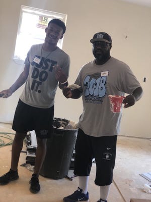 Hunter Huss football coach Jamar McKoy (right) and Duke football commit and Huskies senior standout Tony Davis recently worked at a Habitat for Humanity construction site. [Contributed photo/ Jamar McKoy]