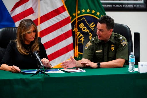 In this June 28, 2018 photo, first lady Melania Trump talks with Rodolfo Karisch, Chief Patrol Agent, Tucson Sector Border Patrol, as she visits a U.S. Customs border and protection facility in Tucson, Ariz. Melania Trump, an immigrant and a mother herself, wanted to find out more about how her husband’s strict immigration policy was playing out on the ground, especially among families that have been separated at the border. Two tours of detention centers along the southern border in a week gave her an explicit and sometimes grim view. Now the question is what she does with that knowledge _ and how she meshes it with her “hate” for dividing up families and belief in “strong borders.” (AP Photo/Carolyn Kaster)