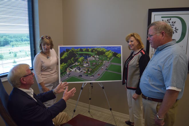 Bob Cooper, left, vice-chair of The Degen Foundation's board of directors, looks over plans for a park at the Arkansas Colleges of Health Education campus in Fort Smith's Chaffee Crossing with Karen Pharis, chair of The Degen Foundation board of directors; Jackie Krutsch, executive director of Development for the Arkansas Colleges of Health Education; and Dr. James Greene, member of The Degen Foundatin's board of directors member. The foundation recently provided $500,000 in grants for a park, pavilion and medical equipment. [Courtesy ACHE]