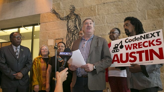 Austin attorney Fred Lewis, center, addresses the media on March 29 after a group of anti-CodeNext advocates filed a petition with the city clerk’s that was backed by more than 31,000 registered voters. The Austin City Council voted down the group’s bid to force a November election regarding CodeNext, the comprehensive rewrite of city land use rules, and now Lewis will argue the merits of the proposal in court.