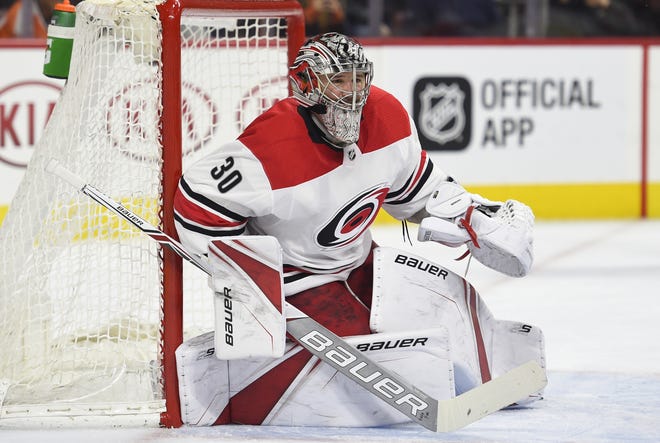 Carolina Hurricanes goalie Cam Ward looks for the puck during the second period of March 1 game against the Philadelphia Flyers in Philadelphia. The Chicago Blackhawks agreed to contracts with free agents Ward, Chris Kunitz and Brandon Manning on Sunday. [AP Photo/Derik Hamilton]