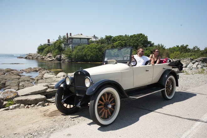 Ken Hudson of Newport Classic Car tours stops at Green Bridge on the Ocean Drive to enjoy the view with Daily News reporter Laura Damon. [PETER SILVIA PHOTO]