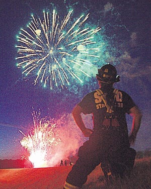 Scott St. Louis of Stroudsburg took this photo of a Stroudsburg firefighter watching the 2013 Freedom Fest Fireworks display. [POCONO RECORD FILE PHOTO]