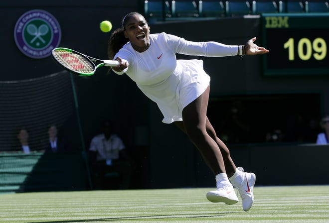 Serena Williams plays a return to Arantxa Rus during their first-round match at the Wimbledon Tennis Championships on Monday in London. [AP Photo/Kirsty Wigglesworth]