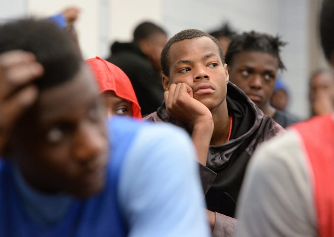 Young men, including Caleb Gunther, 17, right, from Baltimore, listen during a daily talk after lunch as part of the Young Life camp on Friday. [GREG WOHLFORD/ERIE TIMES-NEWS]