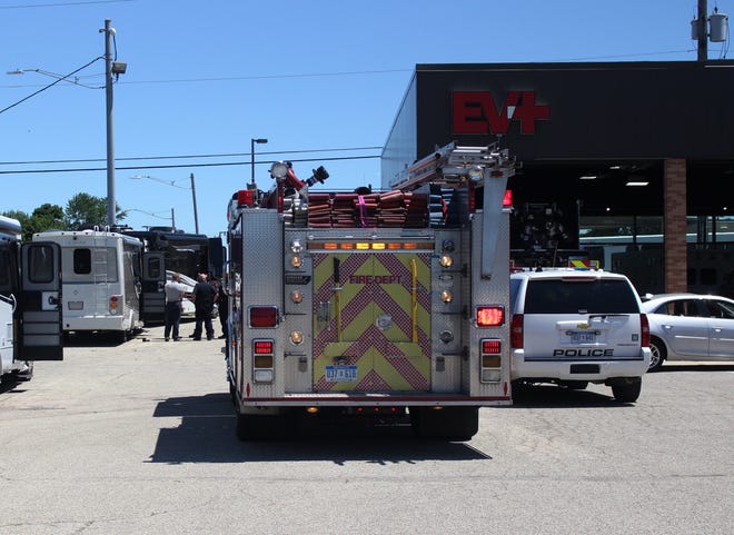 Holland police and firefighters respond to reports of smoke coming out of a motor home at Holland Motor Homes and Bus Co. Monday, July 2. Teenagers allegedly lit a Roman Candle firework and threw it inside a 25-foot motor home on display at the business. [Audra Gamble/Sentinel staff]