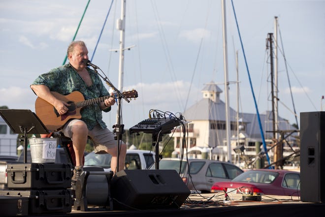 Chuck Foster performs country music at St. Andrews Marina during the Panama City Summer Sunset Series on Tuesday. On Mondays at the Panama City Marina and Tuesdays at the St. Andrews Marina the city will host concerts for the rest of June and all of July. [JOSHUA BOUCHER/THE NEWS HERALD]