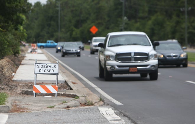 A sidewalk is closed for construction Monday on Tyndall Parkway. [PATTI BLAKE/THE NEWS HERALD]