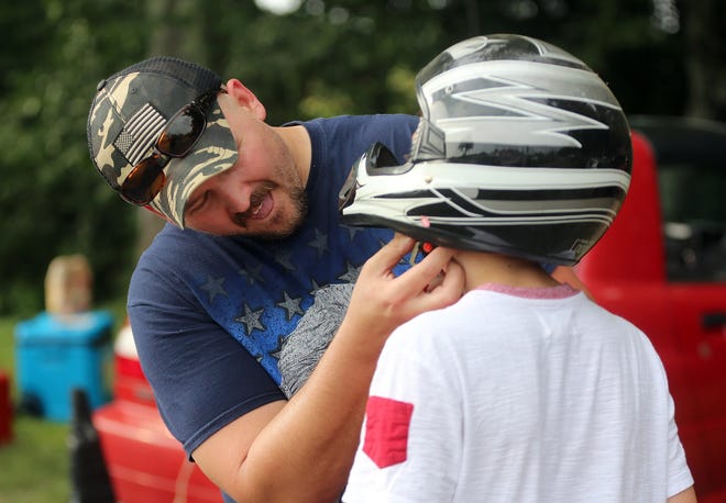 SECONDARY ART



Durand Bagwell helps Zach with his helmet before hopping on a bike at Shadyside Dragway on Thursday. [Brittany Randolph/The Star]