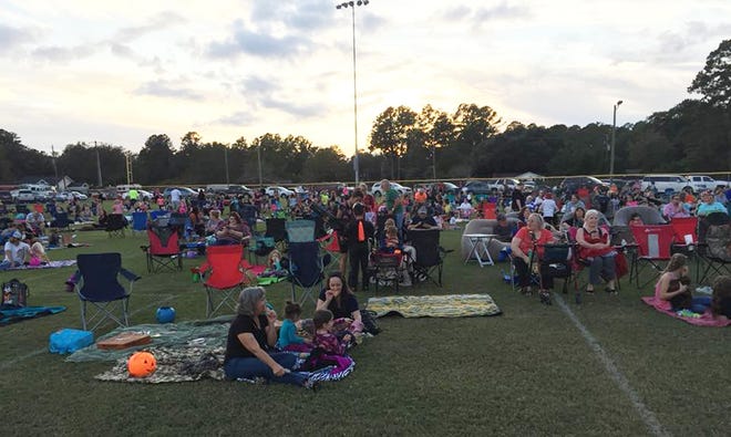 People brought lawn chairs and blankets to see the movie Hocus Pocus in Macomber Park for Halloween last year. The city is buying an outdoor movie system and plans to show movies on a regular basis. [COURTESY RINCON RECREATION]