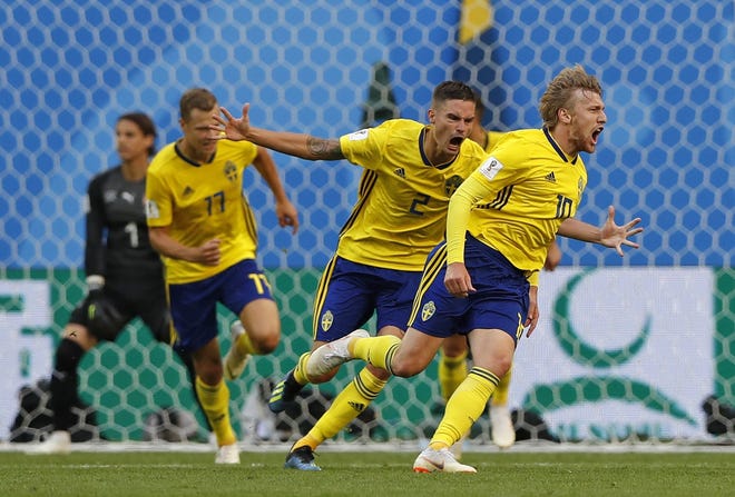 Sweden's Emil Forsberg, right, celebrates with teammates after scoring in a win over Switzerland and Sweden at the World Cup in the St. Petersburg Stadium in on Tuesday. [Darko Bandic/Associated Press]