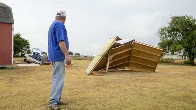 Kenneth Thomison looks at his storage shed that was destroyed by a tornado at his home on Limmer Loop in Hutto on Wednesday July 4, 2018. JAY JANNER / AMERICAN-STATESMAN