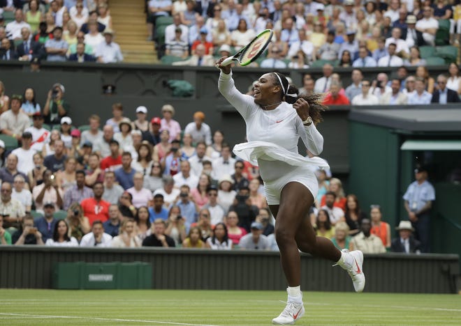 Serena Williams hits a return shot to Bulgaria's Viktoriya Tomova in a women's singles match on the third day of the Wimbledon Tennis Championships in London on Wednesday. [Kirsty Wigglesworth/AP]