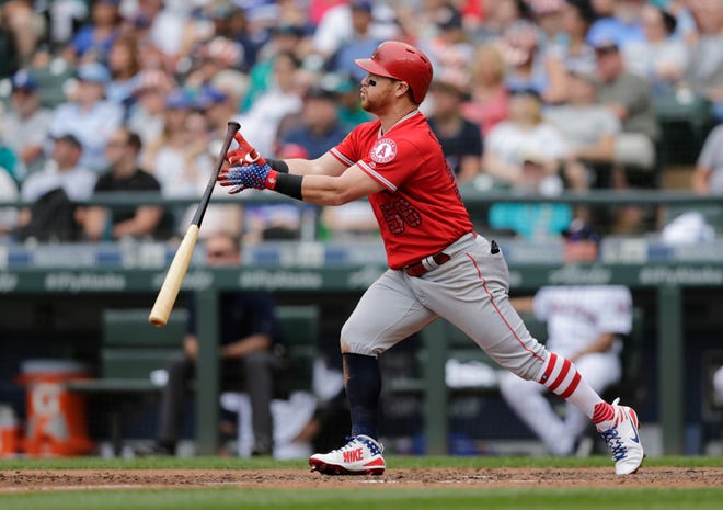 Los Angeles Angels' Kole Calhoun flips his bat after hitting a two-run home run off Seattle Mariners' Nick Rumbelow during the sixth inning of a baseball game Wednesday, July 4, 2018, in Seattle. (AP Photo/John Froschauer)