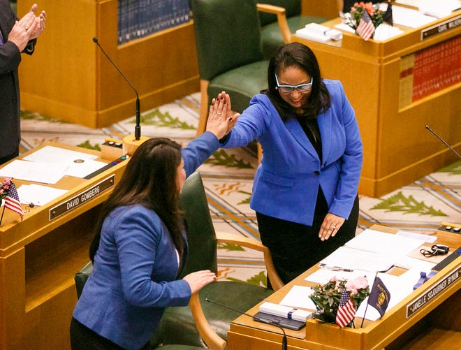 Rep. Janelle Bynum (right) high-fives a colleague after a swearing-in ceremony on the floor of the Oregon House in 2017. [Molly Smith/Statesman-Journal]
