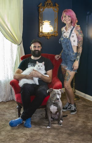 Steve Ehret and Kat Francis at home with their cat Garth and dog Noodle. (CantonRep.com / Bob Rossiter)