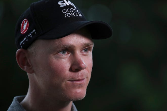 Four-time Tour de France cycling race winner Chris Froome of Britain answers questions during a TV interview after a news conference in Saint-Mars-la-Reorthe, Vendee region, France, on Wednesday ahead of upcoming Saturday's start of the race. [Christophe Ena /The Associated Press]