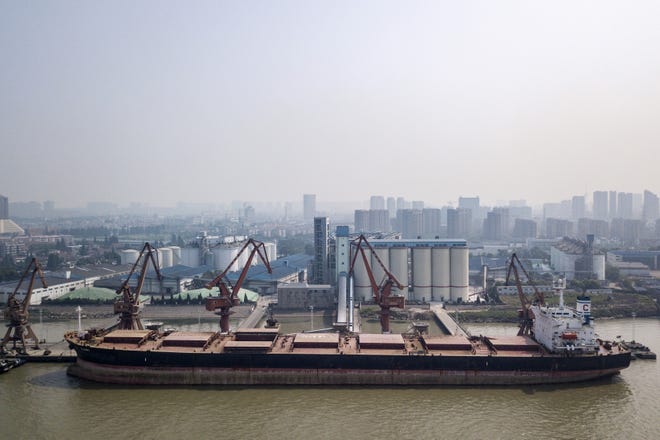 Grain is unloaded from a bulk carrier ship docked at the Nantong Cereals & Oils Transfer Co. facility at the Port of Nantong in Nantong, China, on June 6, 2018. MUST CREDIT: Bloomberg photo by Qilai Shen.