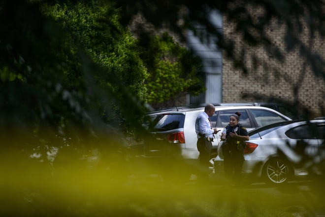 Members of the Fayetteville Police Department talk outside of an apartment where officers responded to a 911 call on July 3, 2018 at Treetop Garden Apartments. [Melissa Sue Gerrits/The Fayetteville Observer]