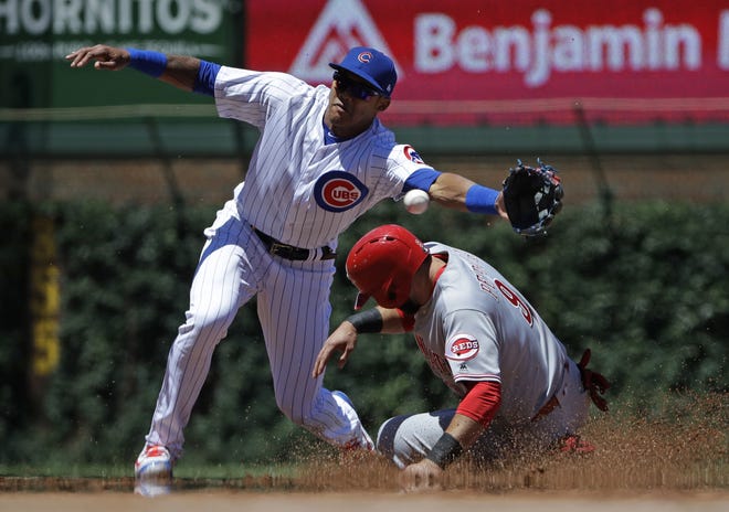 The Cincinnati Reds' Jose Peraza, right, steals second base as Chicago Cubs shortstop Addison Russell tries to catch the throwl during the first inning of Friday's game in Chicago. [AP Photo/Nam Y. Huh]
