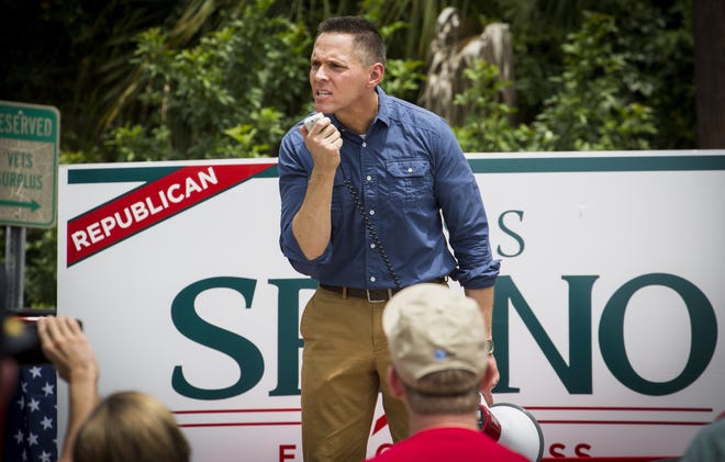State Rep. Ross Spano, a Republican candidate for the District 15 U.S. House seat being vacated by Dennis Ross, speaks to a small group outside Vets Army and Navy Surplus from the back of a pickup truck during a counter-rally to the March for Our Lives event held in Lakeland on Friday. [ ERNST PETERS/THE LEDGER ]