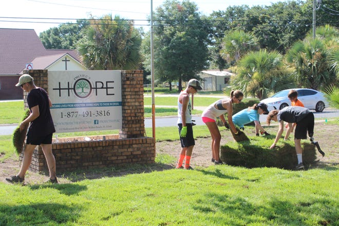 Volunteers from Crosspoint United Methodist Church donated their time last week to lay sod at Project Hope on Hollywood Boulevard in Fort Walton Beach. [CONTRIBUTED PHOTO]