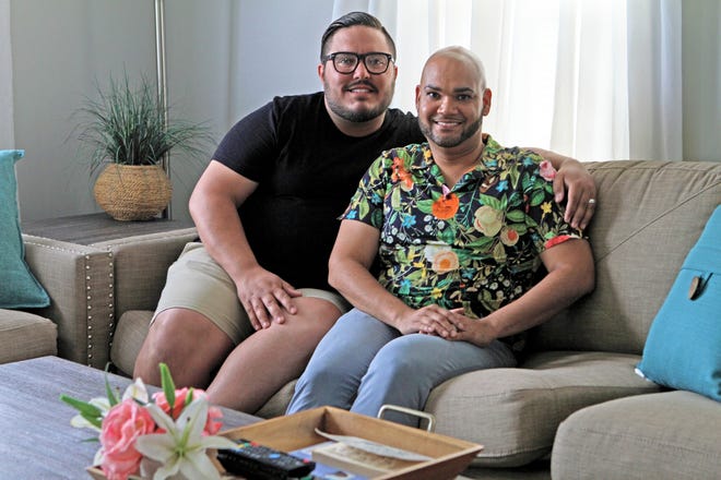 Angel, left, and Jose Torres, at their West Warwick home. They recently became foster parents after attending training in Spanish hosted by Foster Forward, and one day they hope to adopt. [The Providence Journal / David DelPoio]