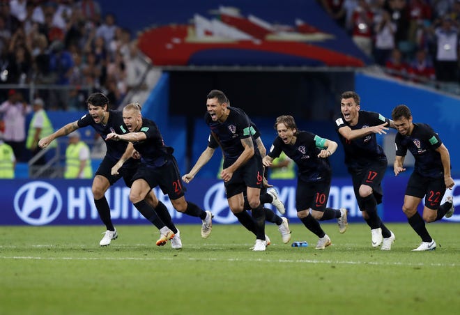 Croatia players celebrate after winning a quarterfinal match against Russia at the World Cup in Sochi, Russia, on Saturday. [AP Photo / Manu Fernandez]