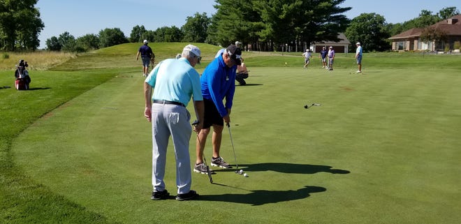 Dave Stockton (left), a former PGA Tour and Champions Tour player, gives instructions during a clinic put on by Stockton Golf on Saturday at Spirit Hollow Golf Course. [Submitted photo]