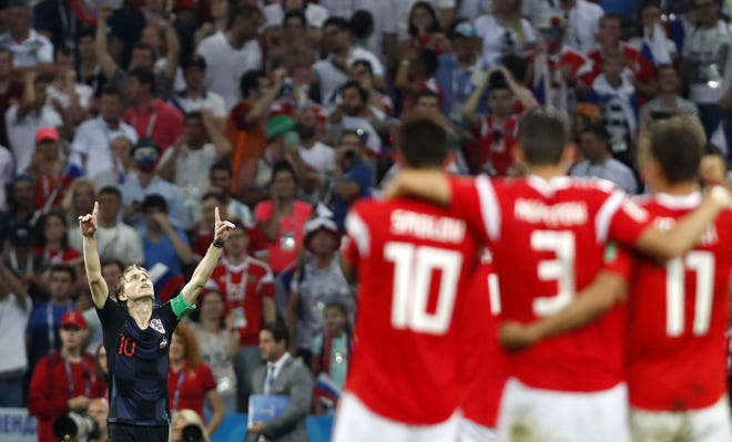 Croatia's Luka Modric, left, celebrates after scores penalty shootout during the quarterfinal match between Russia and Croatia at the World Cup in the Fisht Stadium in Sochi, Russia on Saturday. [AP Photo/Rebecca Blackwell]