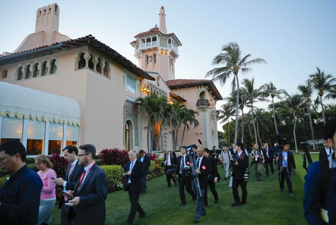 Members of the U.S. and Japanese media walk across the grounds of President Donald Trump's Mar-a-Lago club during an April visit by Japanese Prime Minister Shinzo Abe and his wife, Akie Abe. [PABLO MARTINEZ MONSIVAIS/AP FILE]