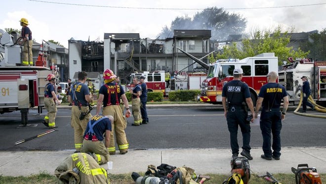 Austin firefighters work a four-alarm fire at Mission James Place Apartments on June 12. JAY JANNER / AMERICAN-STATESMAN