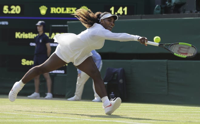 Serena Williams tries to return the ball to France's Kristina Mladenovic during their women's singles match at the Wimbledon Tennis Championships in London on Friday. [AP Photo / Ben Curtis]