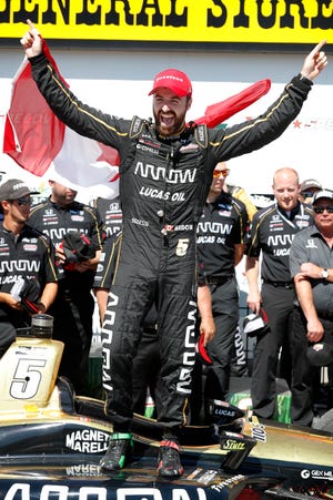 James Hinchcliffe celebrates after winning Sunday's Iowa Corn Indy 300 at Iowa Speedway in Newton. [Charlie Neibergall/The Associated Press]