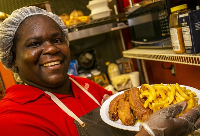 Vickie Drayton shows off the deep fried pork ribs in the kitchen at Gg's Heavenly Soul Food. The restaurant is named after Drayton's grandmother Sarah "GG" Boyle. [Doug Engle/Staff photographer]