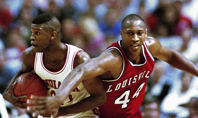 Indiana forward Calbert Cheaney, left, holds on tight to the ball while being challenged by Louisville forward and Southeast High grad Clifford Rozier during the NCAA Midwest Regional game in St. Louis, in 1993. Rozier died of a heart attack Friday. He was 45. [FILE PHOTO / THE ASSOCIATED PRESS]