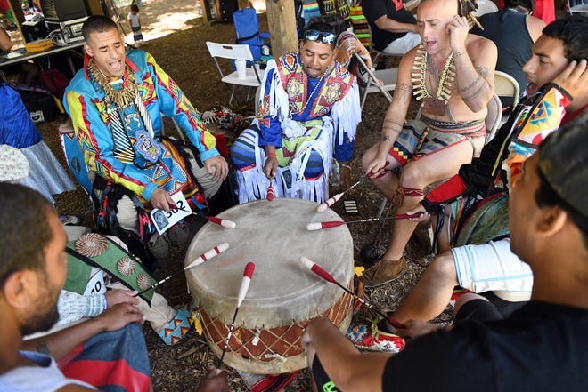 The Red Hawk drum group prepares for the Mashpee Wampanoag Powwow Saturday afternoon at the tribe’s government center. [Gaelen Morse/Cape Cod Times]