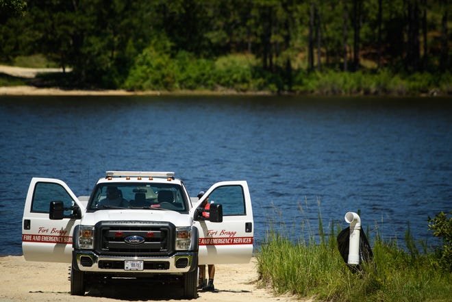 Emergency personnel prepare to leave Mott Lake on Fort Bragg after recovering the body of Micah P. Laymon, 24, who drowned in the lake on Sunday. [Andrew Craft/The Fayetteville Observer]