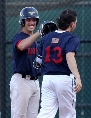 Hanover Post 149 Kyle Sylvester smiles while giving props to Matthew Lanagan after he had hit a home run in the bottom of the first inning of their game against Pembroke at Hanover High on Monday, July 2, 2018. [Wicked Local Staff Photo/ Robin Chan]