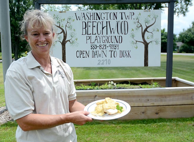 Jenny Skolosh shows off a plate of chicken and biscuits, which will be the centerpiece of a dinner and fundraising event to boost Beechwood Park in Washington Township.