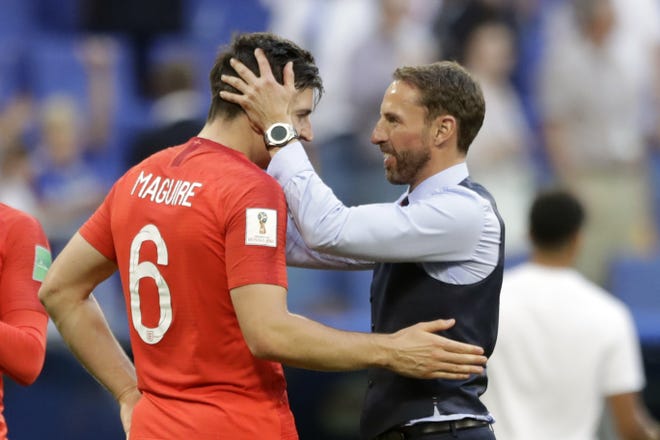 England head coach Gareth Southgate, right, celebrates a win over Sweden with Harry Maguire at the World Cup in Samara, Russia, on Saturday. [AP Photo / Matthias Schrader]
