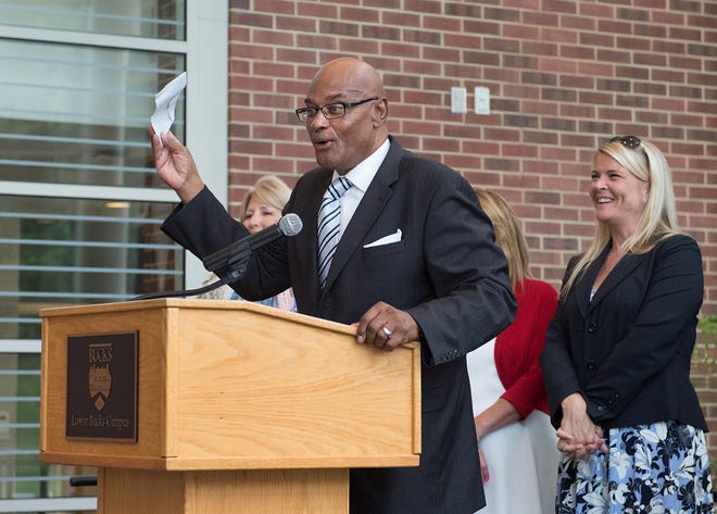 Ron Davis, director of diversity and community development at Parx Casino, holds up a check during a presentation at Bucks County Community College's Gene and Marlene Epstein Campus in Bristol Township on Wednesday. [BILL FRASER / STAFF PHOTOJOURNALIST]