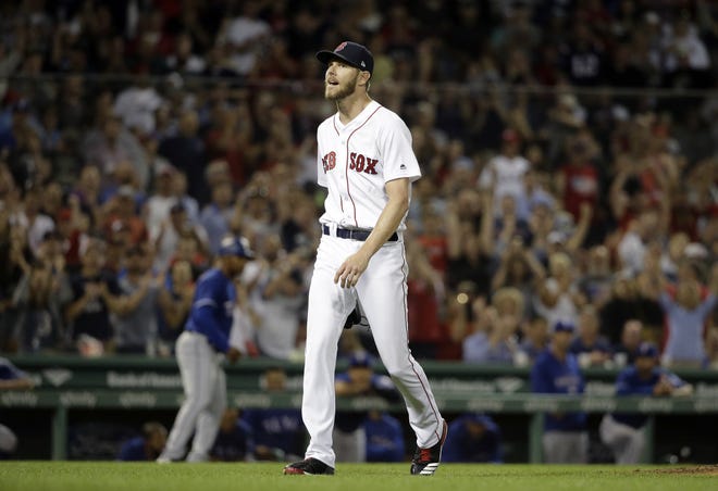 Boston's Chris Sale steps away from the mound after pitching seven scoreless innings with 12 strikeouts against the Rangers on Wednesday night. [Steven Senne/AP]