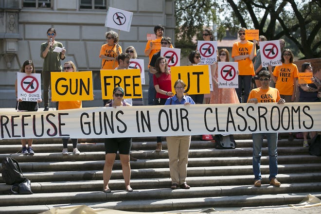 Protesters gather on the West Mall of the University of Texas campus in Austin on Oct. 1, 2015, to oppose a new state law that expands the rights of concealed handgun license holders to carry their weapons on public college campuses and as of Aug. 1, 2016, they can carry in campus buildings. Attorneys for three University of Texas professors were set to ask a federal appeals court Wednesday to revive their lawsuit against the law allowing people with concealed-handgun licenses to carry weapons on public campuses. [Ralph Barrera/Austin American-Statesman via AP, File]
