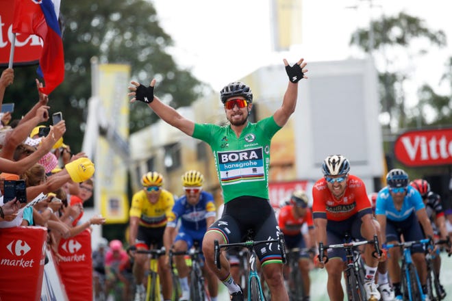 Slovakia's Peter Sagan, wearing the best sprinter's green jersey, celebrates as he crosses the finish line to win the fifth stage of the Tour de France on Wednesday. [AP Photo/Christophe Ena]