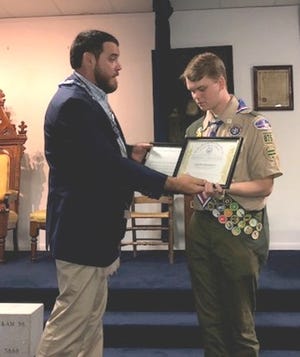 Fred Bozard presents Eagle Scout Caleb Arsenault with a Grand Lodge of Florida certificate and letter of recognition June 21. Arsenault earned Eagle Scout rank, the highest rank in scouting, in March 2018. [Contributed]
