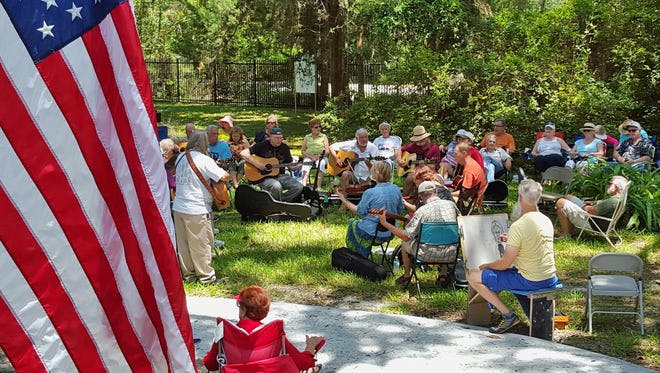 Local musicians jam on the front lawn of the Mandarin Museum in Walter Jones Historical Park at 11964 Mandarin Road during a recent "Music Under the Oaks" jam session. [Dan Scanlan/Florida Times-Union]